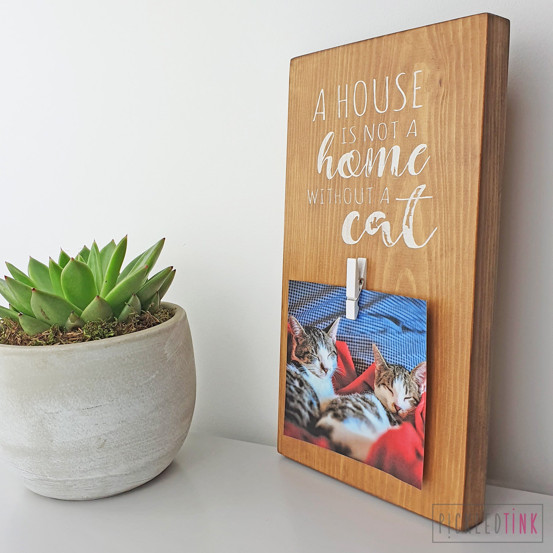 A house is not a home without a cat - Peg Photo Frame